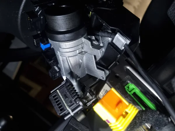 Experienced auto locksmith carrying out ignition cylinder repair and replacement on a vehicle.